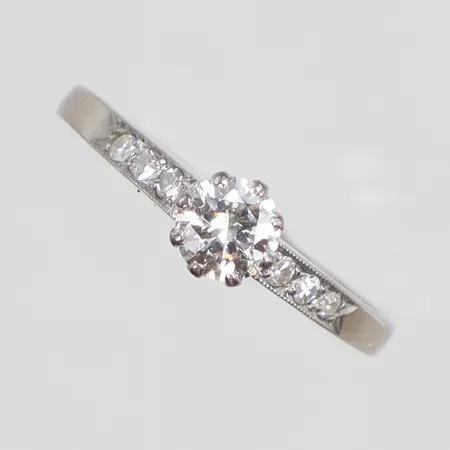 Ring i vitguld med diamanter 1xca0,35 (kvalitet ca Si/W) samt 6xca0,01-0,02ct stl:16¼ bredd 1,5-5mm AEN (Atelier Ajour) Stockholm 1958, 18K Vikt: 2,2 g