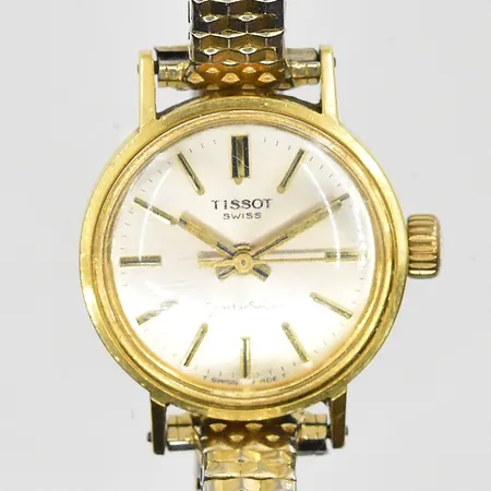 Damur Tissot Seastar Seven 18K, manuell, Ø22mm, flexband i doublé, trög krona, graverad bakboett, inga tillbehör. Bruttovikt 22,8g.