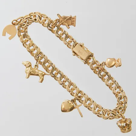 Armband Bismarck med sex berlocker, längd ca 17cm, bredd 6-22mm, tre berlocker i 18K, slitage, 14K, bruttovikt: 15,9g. 