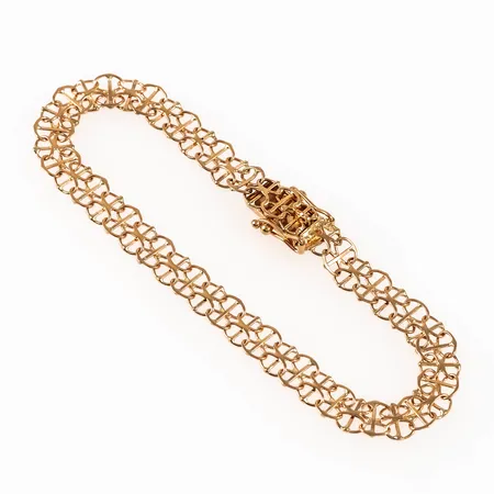 Armband X-länk med stav i 18K guld. Det är 18 cm långt, 6,5 mm brett och väger 5,8g. Kistlås. 