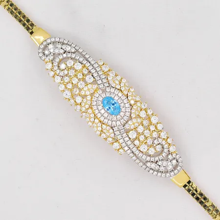 Armband 17cm, infattad med blå topas och vita stenar, guld och vitguld, bredd 3,2-17,5mm, 14K Vikt: 11,2 g