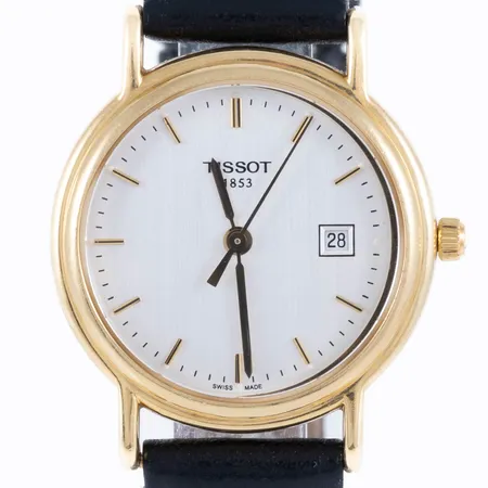 Damur Tissot i 18K guld med svart läderband. Boett Ø 26,5 mm, datumvisare, safirglas, quartz, gravyr "För nit och redlighet...", defekt krona, går ej attställa. Bruttovikt: 21,4g.