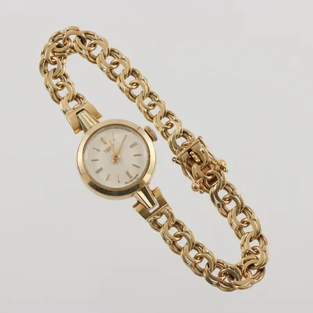 Damur Tissot 14K, 19,5mm, manuell, Klockarmband Bismarck i 18K, längd inklusive uret: 16,5cm, bredd: 6,7mm, bruttovikt: 20,3g.