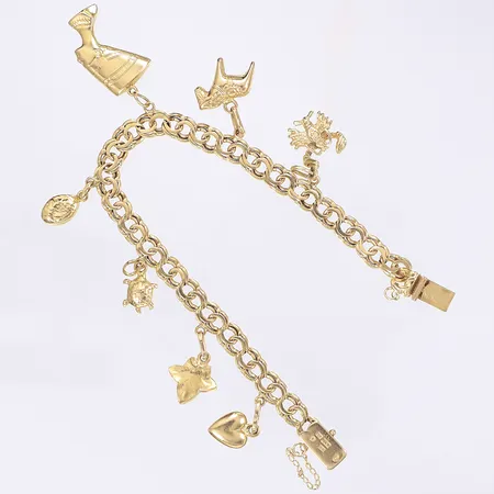 Armband Bismarck med sju berlocker 19cm bredd 6mm saknar säkerhetsåttor samt defekt säkerhetskedja 18K  Vikt: 18,7 g