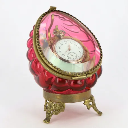 Fickursställ med fickur i silver, ställ i gulmetall och rosatonat glas, höjd ca 11cm, fickur Ø35mm, innerboett i metall, brv: 35,5 gram 