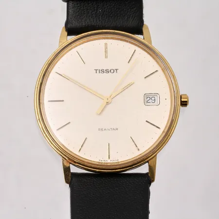 Herrur Tissot Seastar i 14K guld Ø33mm, datum, personlig gravyr på boett, läderband, inga tillbehör. Vikt: 0 g