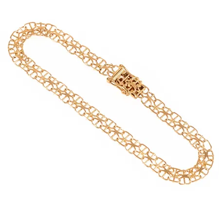 Armband X-länk med stav i 18K guld. Det är 19 cm långt, 5,5 mm brett och väger 5,9g. Kistlås. 