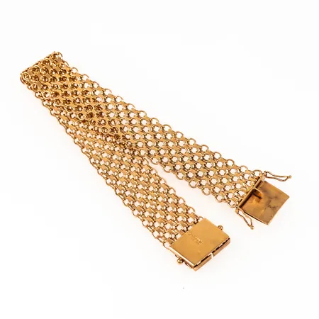 Armband x-länk i 18K guld. Det är 19,5 cm långt, 16,3 mm brett och väger 23,8g. Kistlås.