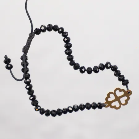 Armband med gulddetaljer och svarta stenar 18k   brutto  Vikt: 3,8 g