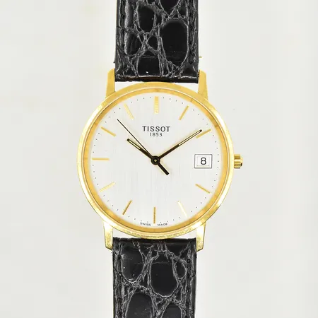 Herrur Tissot 18K, datum, quartz, boett Ø 34 mm, datum, gravyr på boett, fungerade vid testtillfället, svart läderarmband, etui.