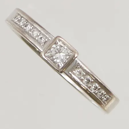 Ring diamanter, 11x diamanter 0,30ctv enligt gravyr, (mittsten princesslipad ca 0,20ct), ca Ø17, bredd:4mm, Schalin, originaletui, vitguld, 18K 4,9g.