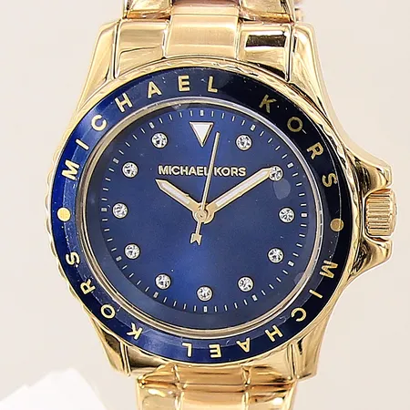 Damur Michael Kors Kenly, MK-6954, stål/gulmetall, quartz, Ø33mm, serie-nr: 112104, länk i stål, urtavla med vita stenar, inplastade länkar, tag, nyskick, batteri byte krävs, inga tillbehör