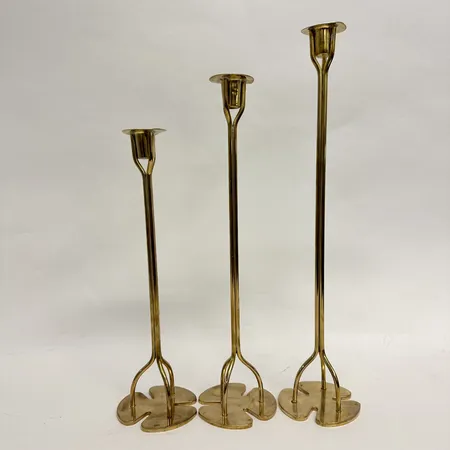 Tre ljusstakar, Firma svenskt tenn, ur serien klöver, design Josef Frank, mässing, höjd 30,5+35,5+40,5cm, skeva manschetter, märkta undertill, bruksslitage Skickas med postpaket.