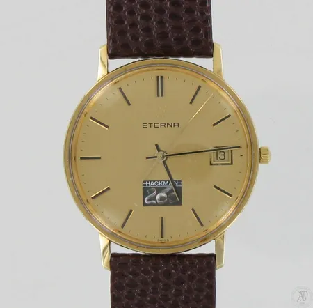 Kultarannekello Eterna, Hackman 200- kuvalla, kaiverrettu, quartz, paristo loppunut,  taulun Ø 33mm, nahkahihna kulunut, 585br, paino 25,5g Paino: 25,5 g