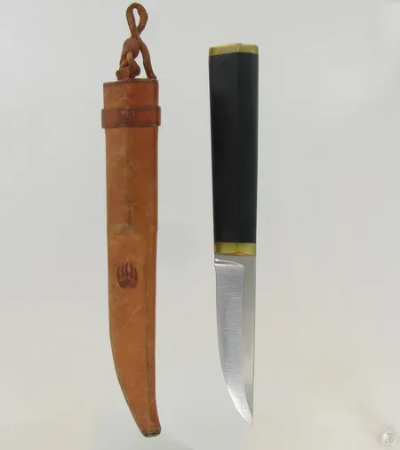 Puukko, design Tapio wirkkala, ruostumatonta terästä, nailonia ja messinkiä, nahkatuppi 