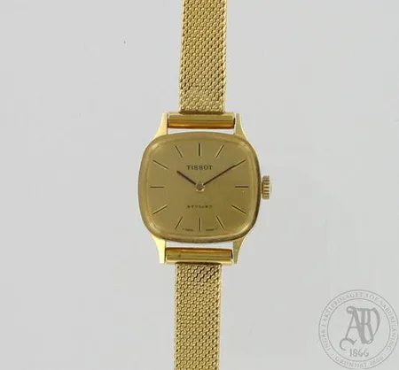 Naisten kultarannekello Tissot Stylist, takakansi kaiverrettu, Ø 23mm, ranneke metallia, 750br, paino 26,1g Paino: 26,1 g