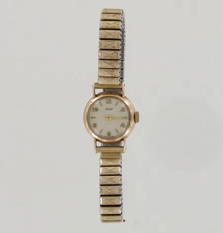 Kultarannekello Tissot, käytön jälkiä, mekaaninen, taulun Ø 20mm, joustinranneke metallia, 585br, paino 26,4g