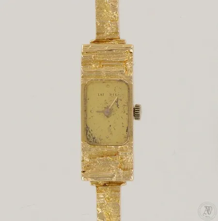 Kultarannekello Lapponia, design Björn Weckström, vuodelta 1984, quartz, taulu viallinen, taulun mitat 11x30mm, rannekkeen pituus 180mm, 750br, paino 30,0g