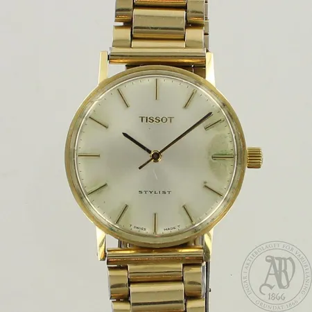 Kultarannekello Tissot Stylist, kaiverrettu, mekaaninen, taulussa ja lasissa kulumia, taulun Ø 33mm, ranneke metallia,  585br, paino 57,8g 