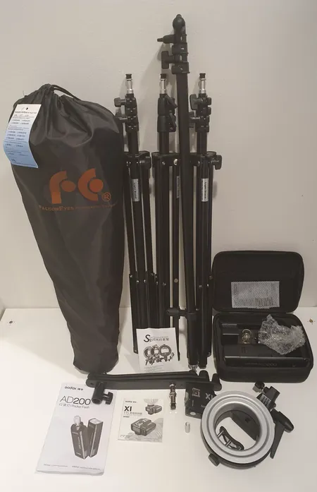 Valokuvaustarvikkeita: Godox S-type Bracket Bowens- salama adapteri, Godox Witstro AD200 Kit - akkusalamapaketti, Falcon Eyes LRB-0378 jalusta heijastimille, 3 kappaletta Falcon Eyes I-2001 82-200cm salamajalustaa ja Falcon Eyes Octabox FEOB-11HC kokoontaitettavas + hunajakenno 110cm. Ostokuitti 24.03.2018. Ota yhteys panttilainaamoon kuljetusmaksusta sopimiseksi.