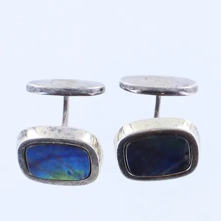 Spektroliitti-kalvosinnapit, kaiverrettu, niimileima AT eli OY Tillander AB, kivissä pieniä käytön jälkiä, mitat 18,2x20,2mm, 925br, paino 20,6g Paino: 20,6 g