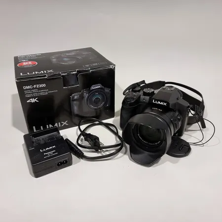 Panasonic FZ300 -digikamera, akku, laturi ja laatikko, rungossa normaalia käytön jälkeä, linssissä muutama pieni jälki Lähetetään postipakettina.