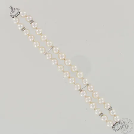Helmirannekoru timanteilla 20xn.0.02ct 12xn.0.01ct, helmien halkaisia noin 8,5mm (cultured salt water), pituus 195mm, 585br valkokulta,  Paino: 39,4 g