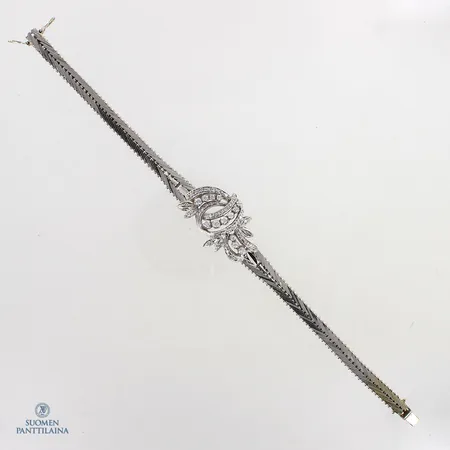 Timanttirannekoru 3xn.0.06ct 1xn.0.05ct 1xn.0.04ct 2xn0.03ct 4xn0.02ct 1xn0.01ct 38xn.0.005ct, pituus 190mm, 750valkokulta,  Paino: 27,9 g