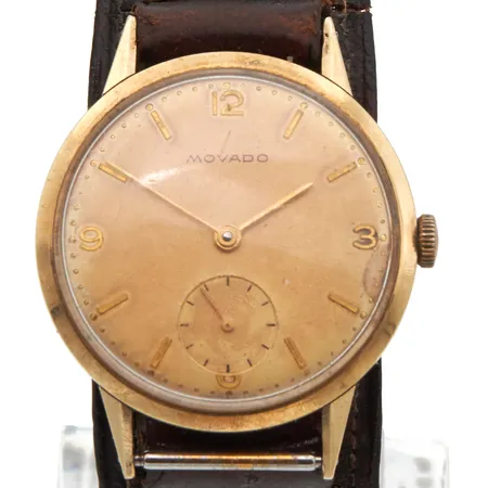 Kultarannekello Movado, kaiverrettu, manuaalinen, 585br, rungon Ø33mm, pleksilasissa naarmuja, ranneke kulunut, nahkarannekkeen pituus 170-210mm,   Paino: 35,1 g