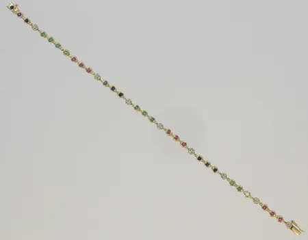 Rannekoru rubiineilla, safiireilla, smaragdeilla ja timanteilla 9xn.0.005ct, 1 kivi puuttuu, pituus 19cm, 585br, paino 8,5g Vikt: 8,5 g